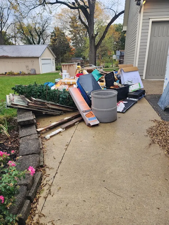 Dumpster being loaded with debris for Estate Cleanout Dumpster Rental in Newberry